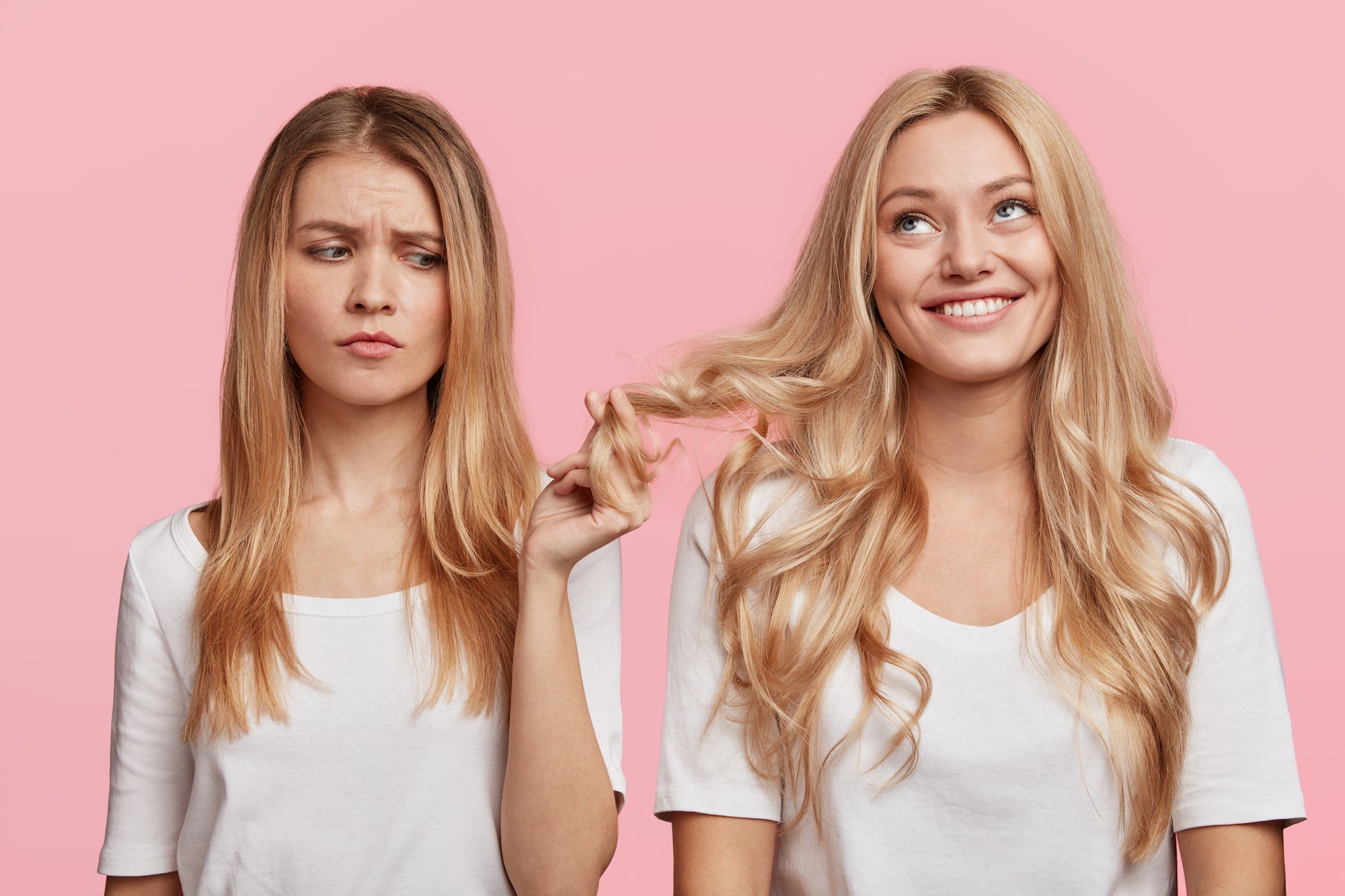 girl with oily hair looking annoyed at and touching other girls hair which is cleaner looking